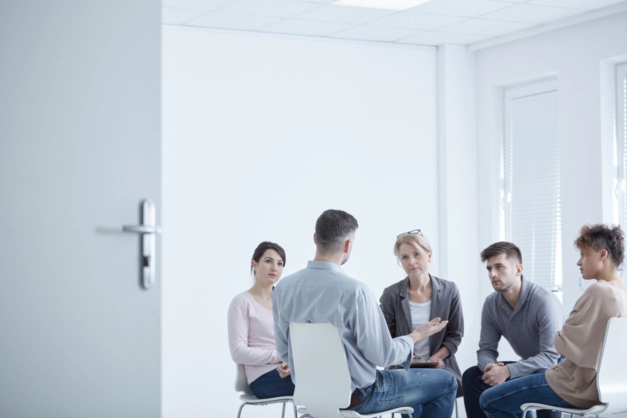 Support group discussion in a bright room.